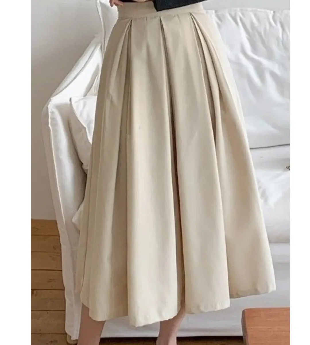 High-waist beige pleated midi skirt with flowy silhouette