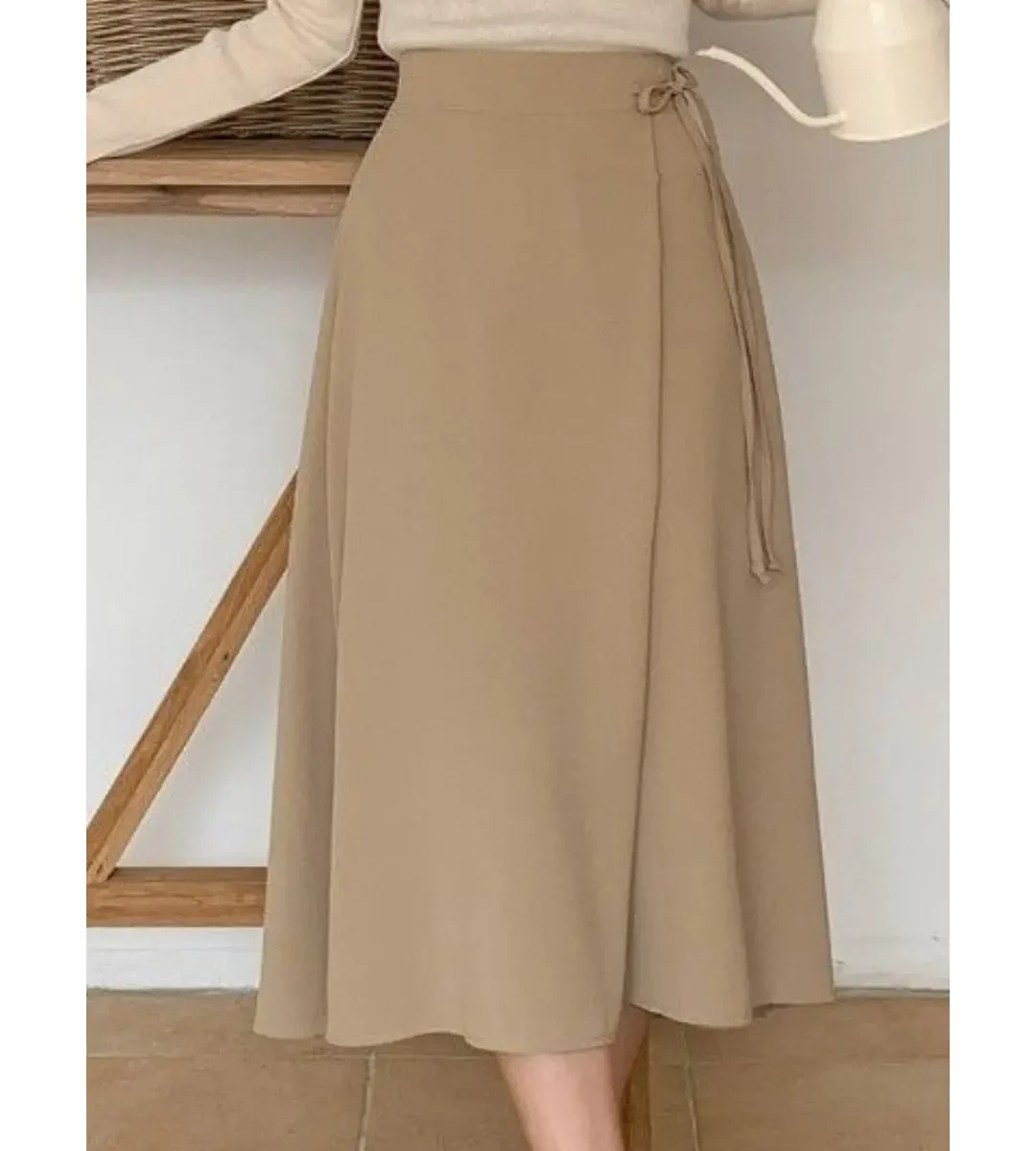 Beige high-waisted wrap midi skirt with side tie and flowy silhouette