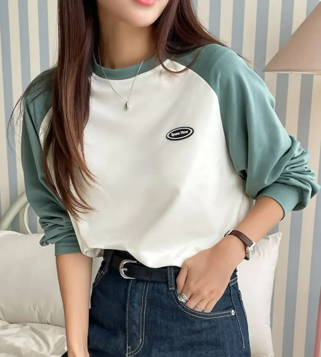 Green and white colorblock raglan sleeve t-shirt worn by a woman