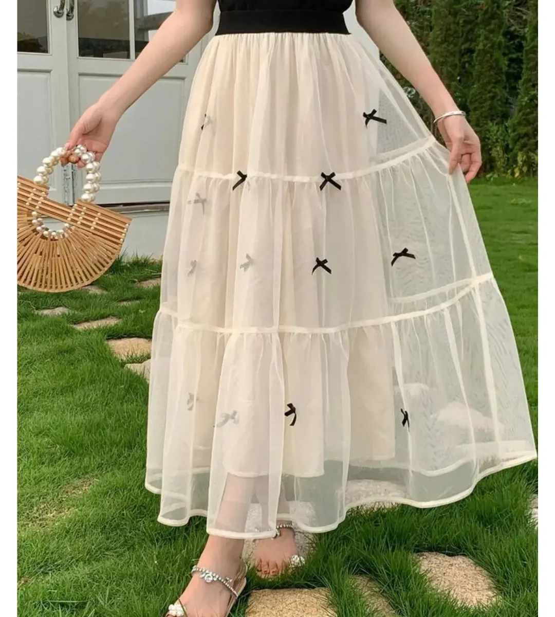 Korean-style sheer layered midi skirt with bow detailing in cream color
