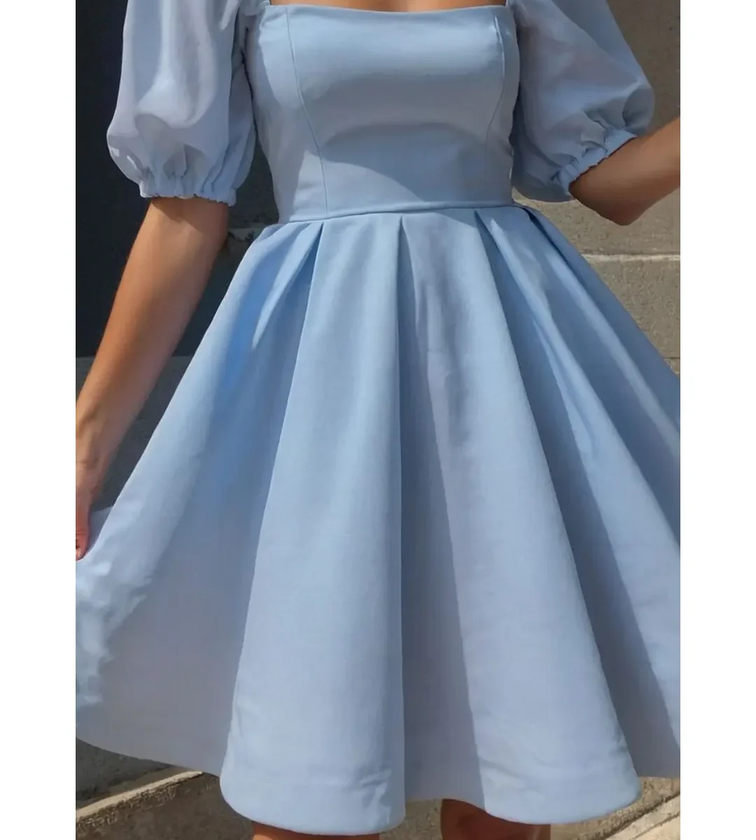 Light blue puff-sleeve fit-and-flare dress worn by a woman