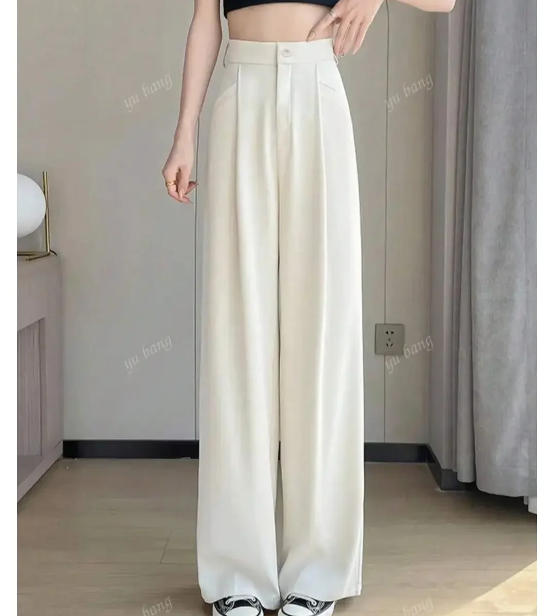 White high-waisted wide-leg trousers with pleated front worn by a woman